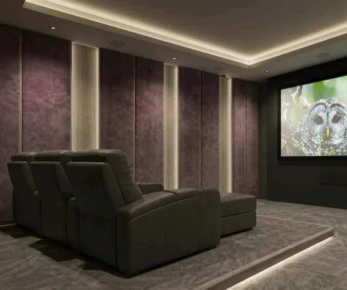 Luxury basement home cinema with tiered seating and warm concealed lighting