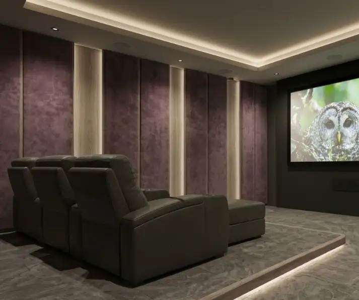 Luxury basement home cinema with tiered seating and warm concealed lighting
