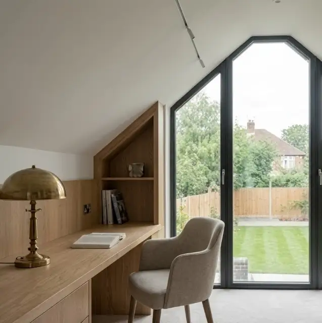Loft home office with built-in oak desk and arched gable window